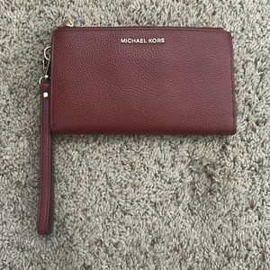 Lightly used dark red Michael Kors wallet with gold accents